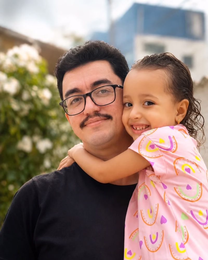 Carlos with family, sharing a hug